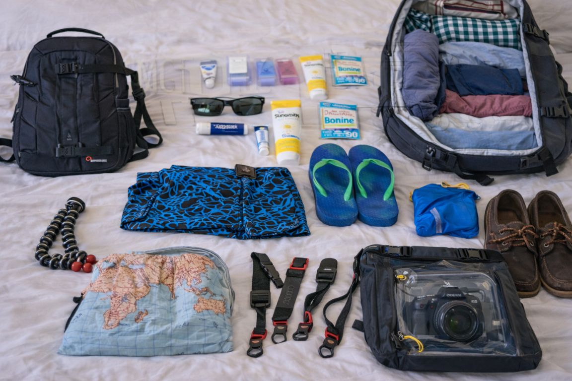 Essential items for a whale watching boat tour in Cabo, including polarized sunglasses, motion sickness medication, and camera straps